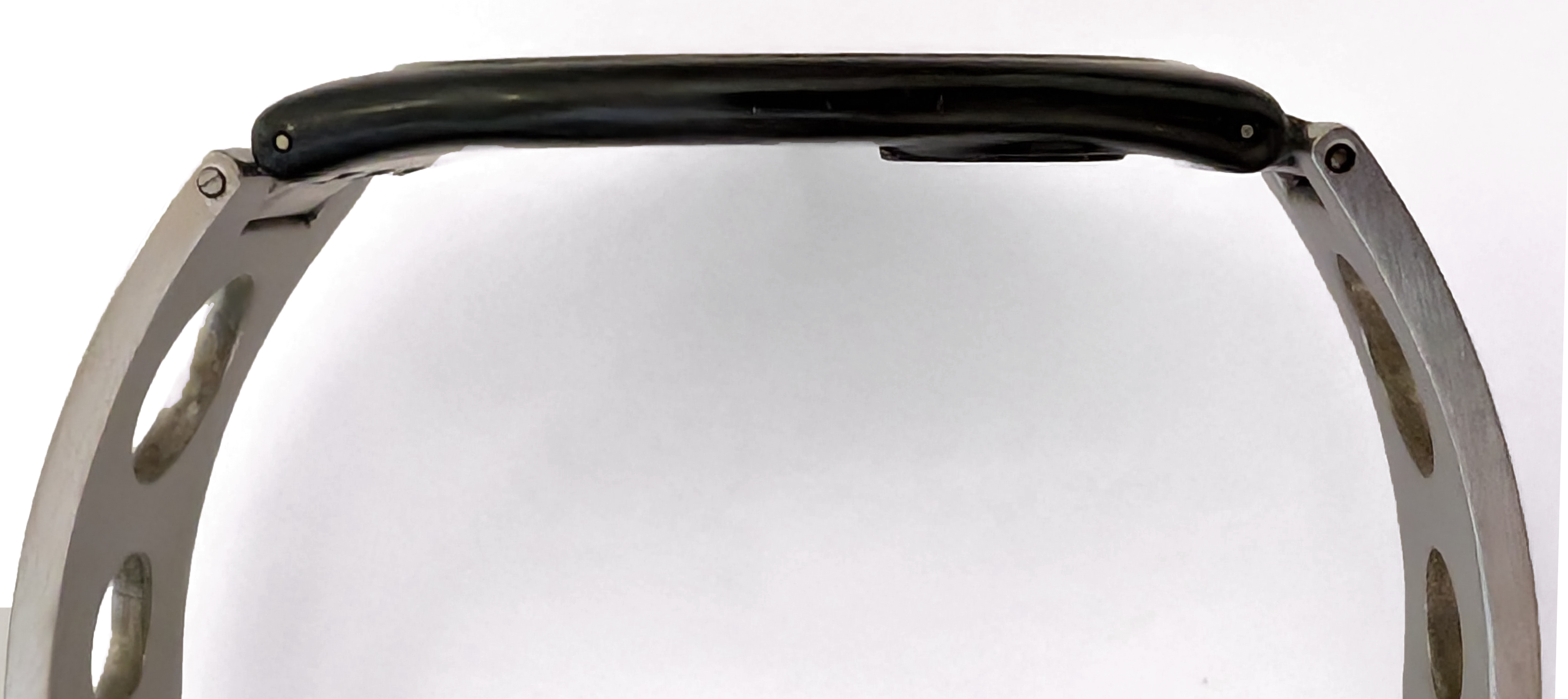 Close-up view of a thin analog Swatch watch showing the side profile and thin it really is.